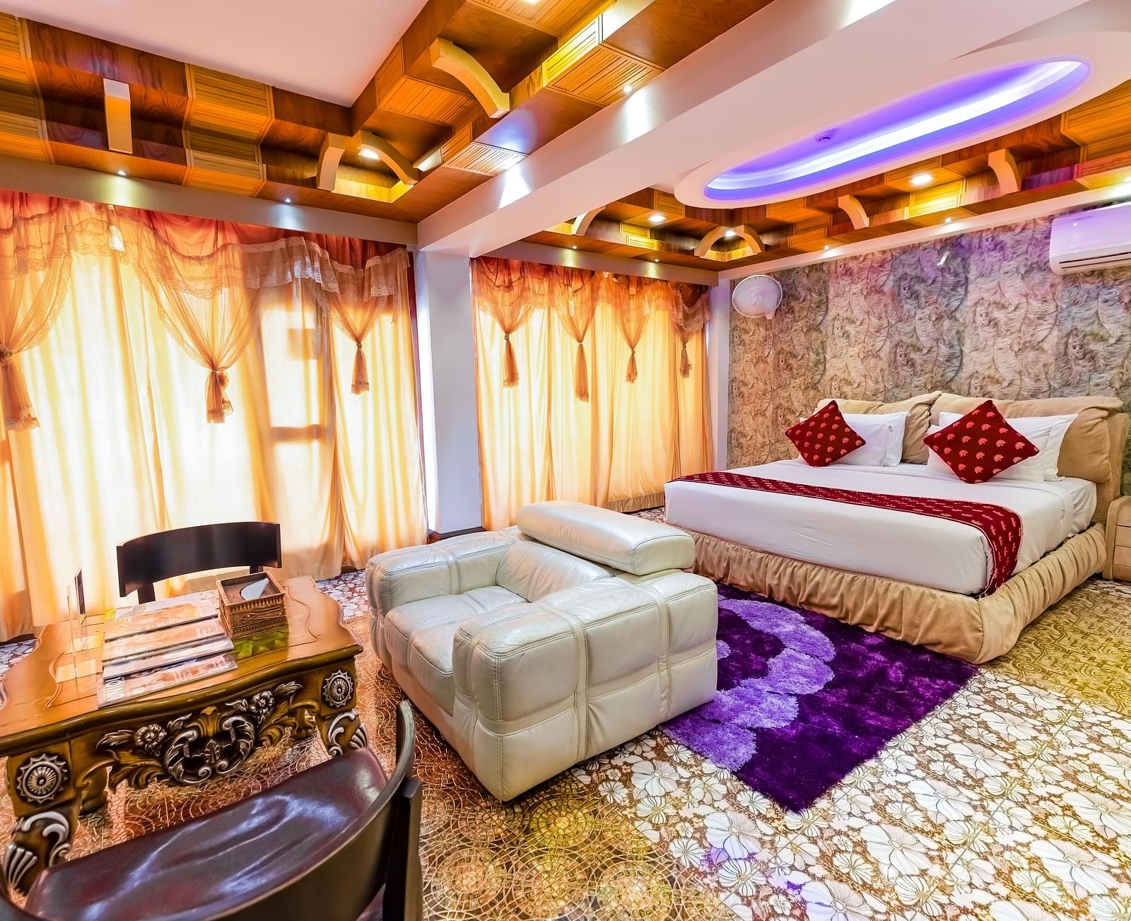 Living area and king size bed in the Presidential Suite at Parakkat Nature Hotel and Resorts Munnar 5