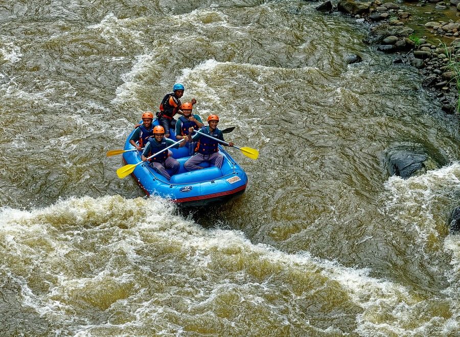 Aerial view of river rafting on a flowing river, showcasing the excitement of adventure amidst the natural landscape.