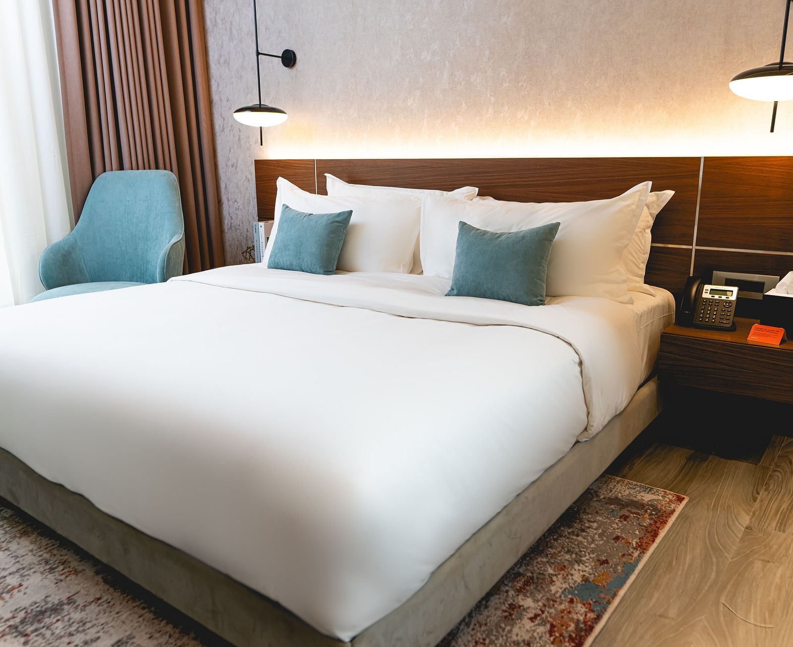 An overview of a bedroom with plush bedding inside two bedroom suite - kertel suites, kinshasa