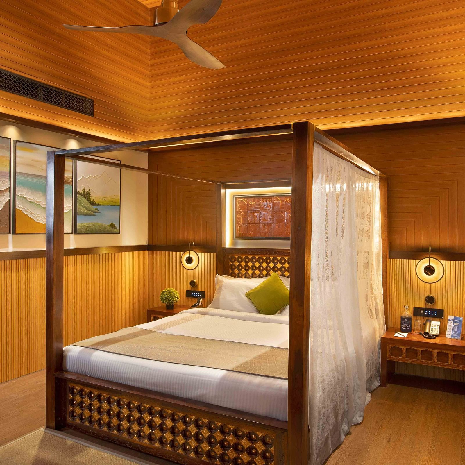 A luxurious wooden framed bed with cosy mattress and curtains, in a room with wooden decor and warm lighting.