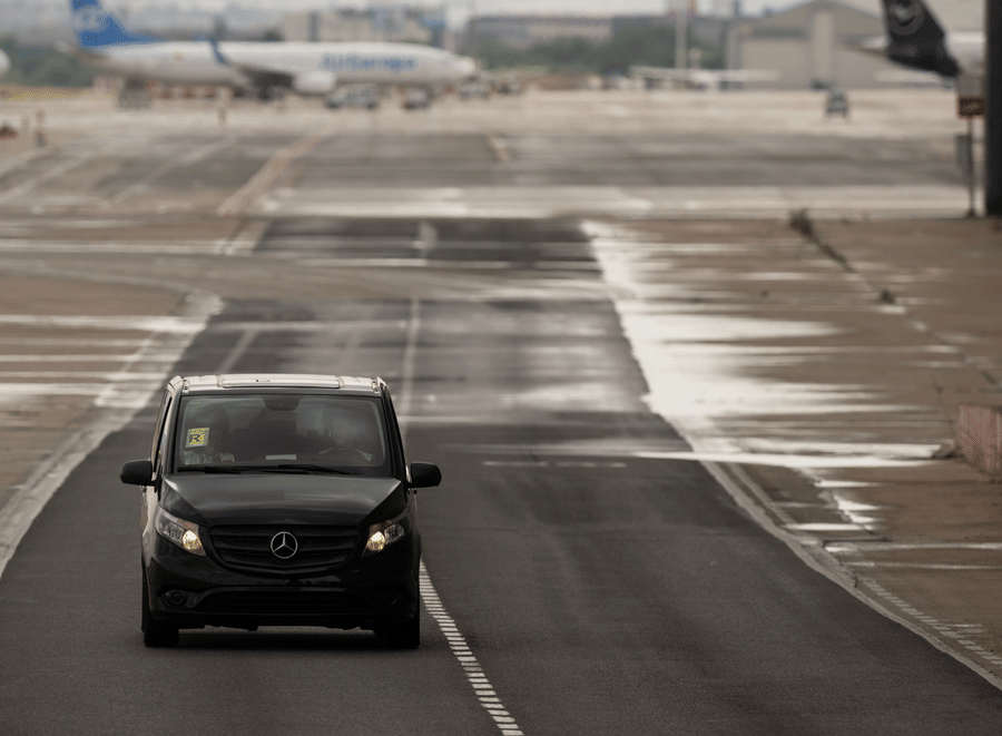 A vehicle on an open road representing airport transfer and cab service available at Bhavanis Vista By Icon Hosur.