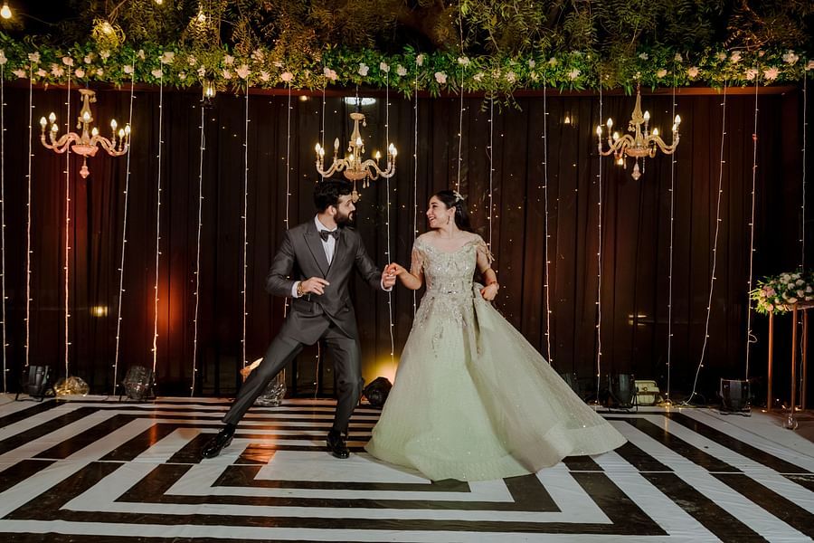 A couple dances on checkered floor in soft light - Umaid Palace - Best Luxury Heritage Resort Near Jaipur
