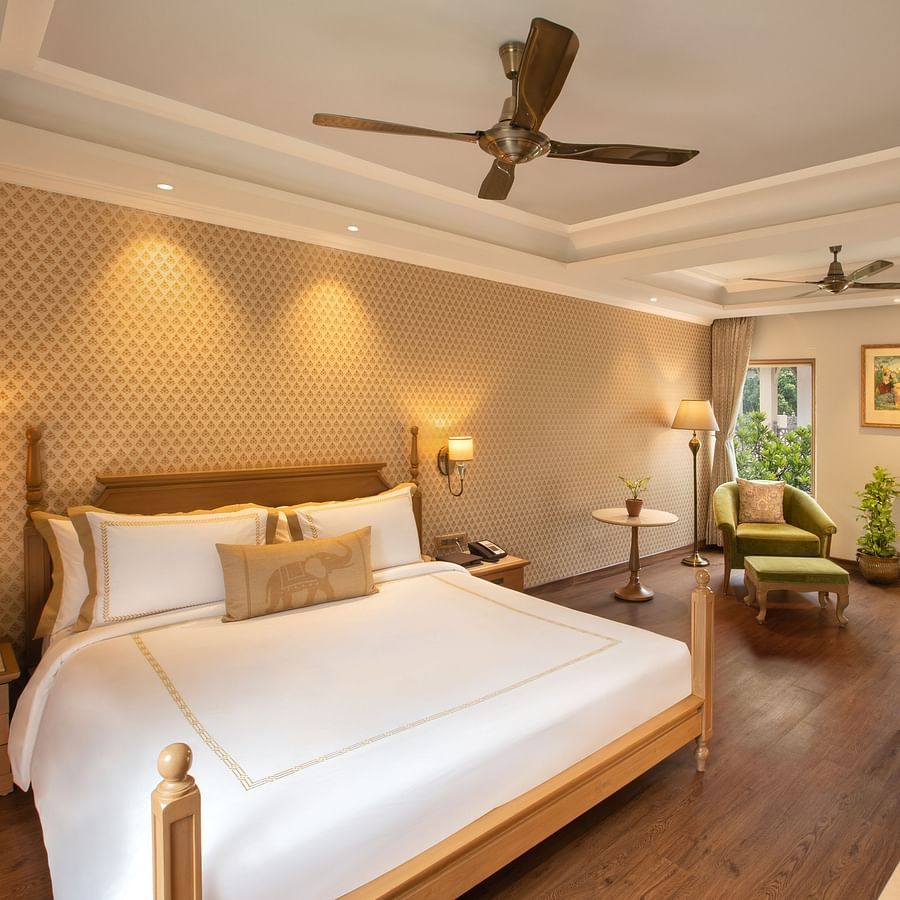 suite in manesar with a comfy king size bed, lavish interiors and wooden flooring at heritage village resort and spa