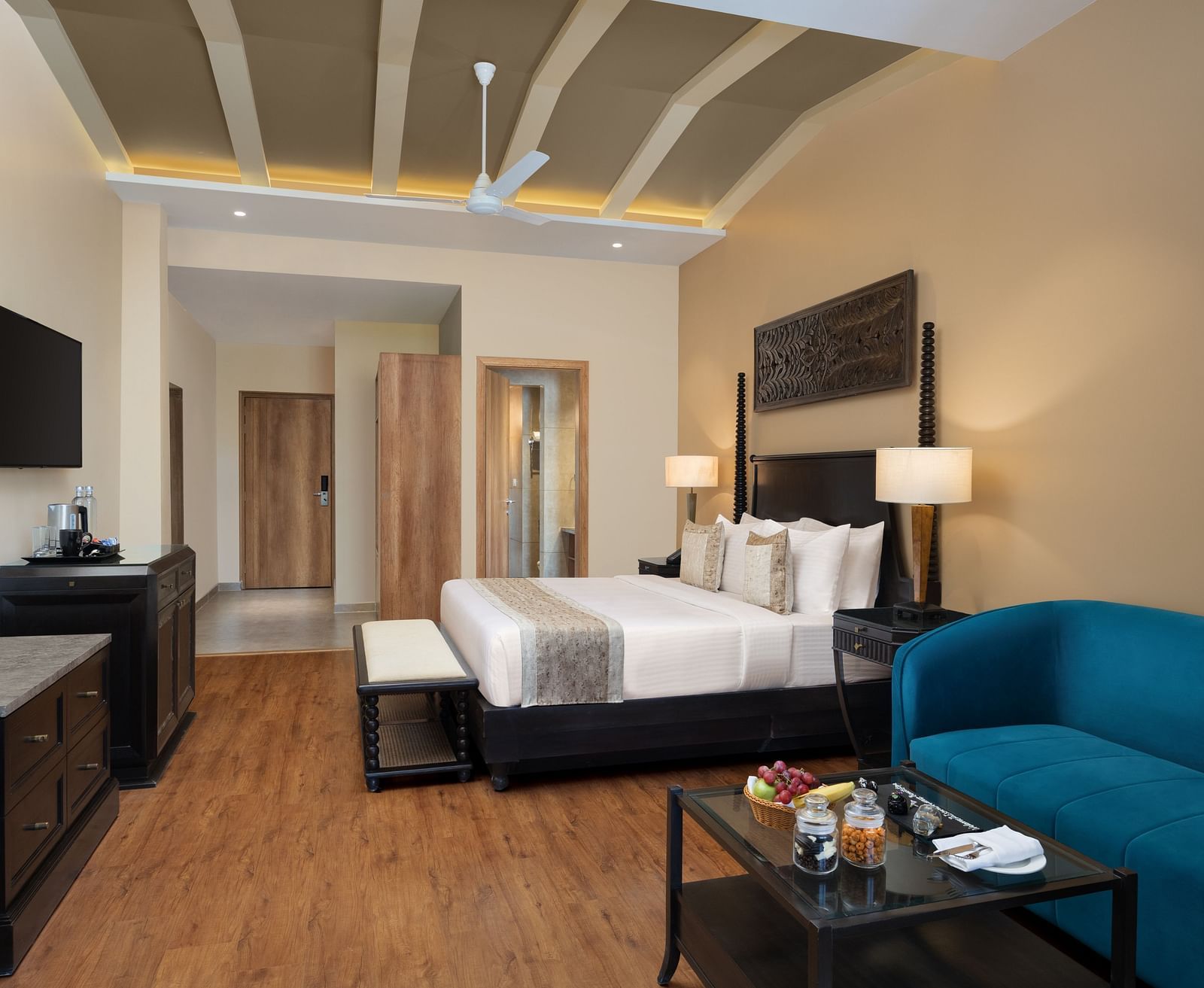 Premium room with a king size bed placed in front of a TV at Essentia Luxury Resort & Spa, Udaipur.