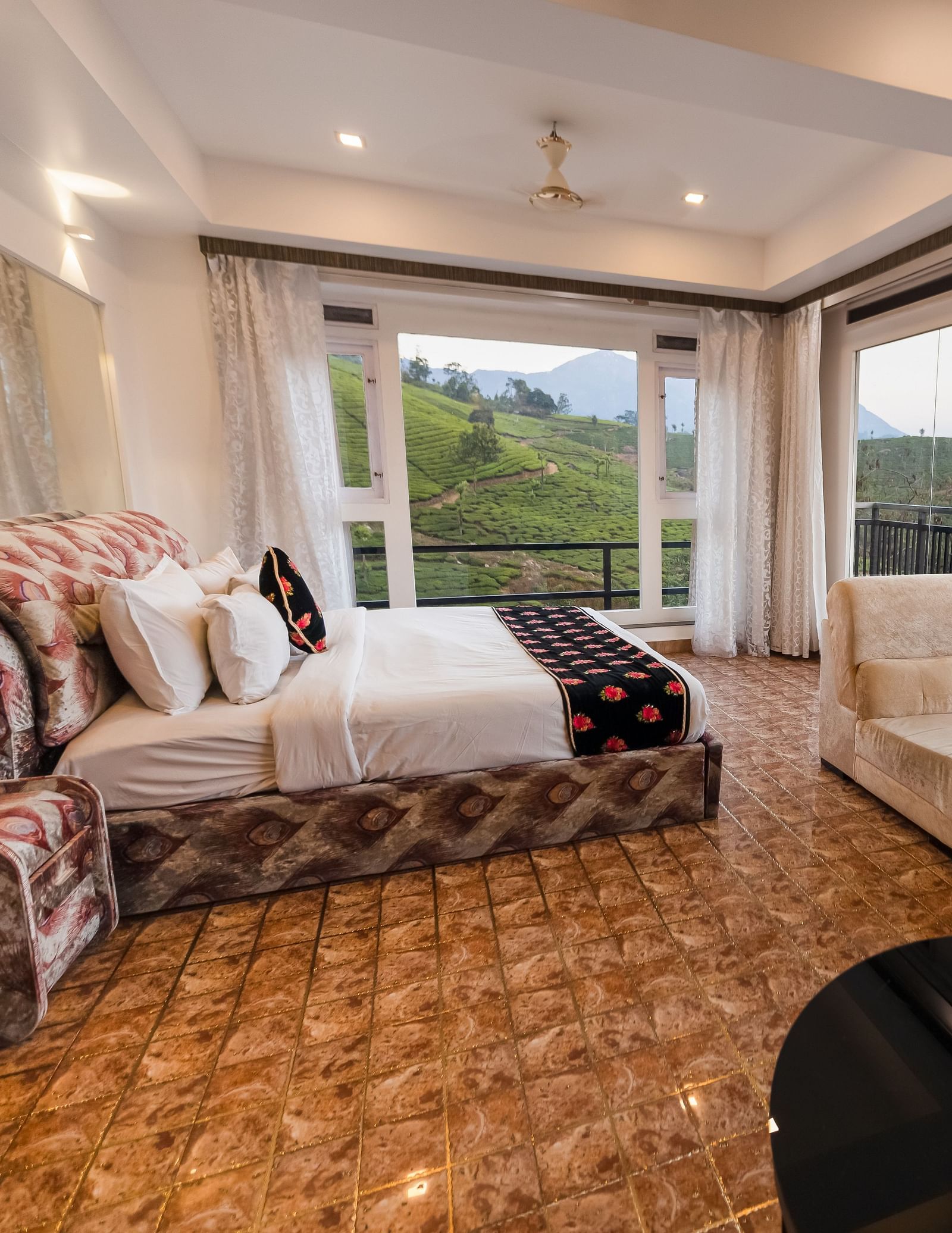 Side view of the bed and sofas at the Family Interconnected Club Suite Parakkat Nature Hotel and Resorts Munnar 1