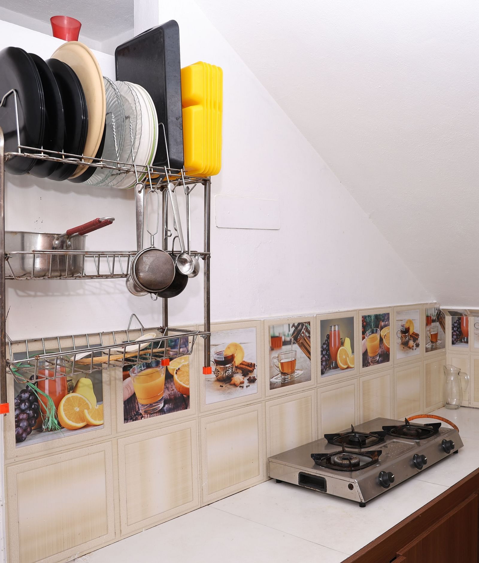 Image of a kitchen equipped with a stove and cutleries at Villa Serenity Le Sejour, Pondicherry.