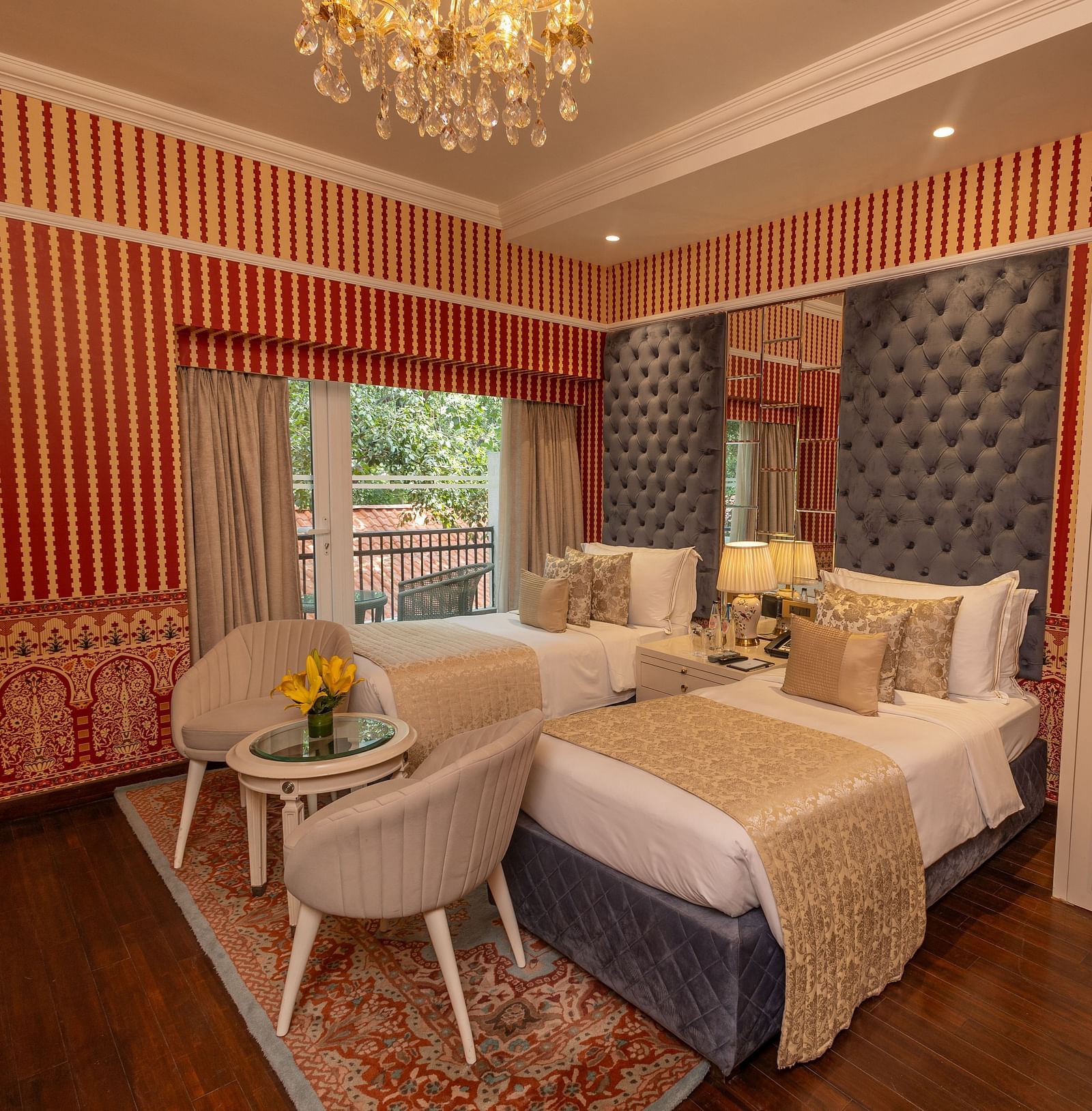 Luxury Twin Bed Room with Balcony at The Claridges New Delhi, featuring twin beds with pillows and a large window with a view