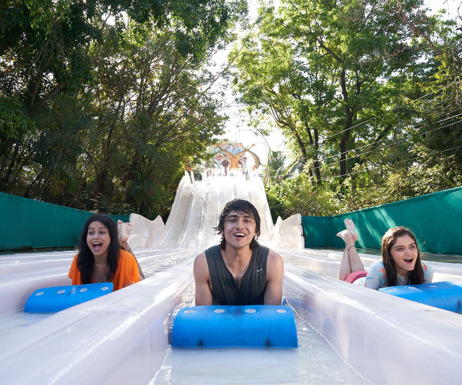 Three people enjoying What-A-Coaster at Water Kingdom while sliding down