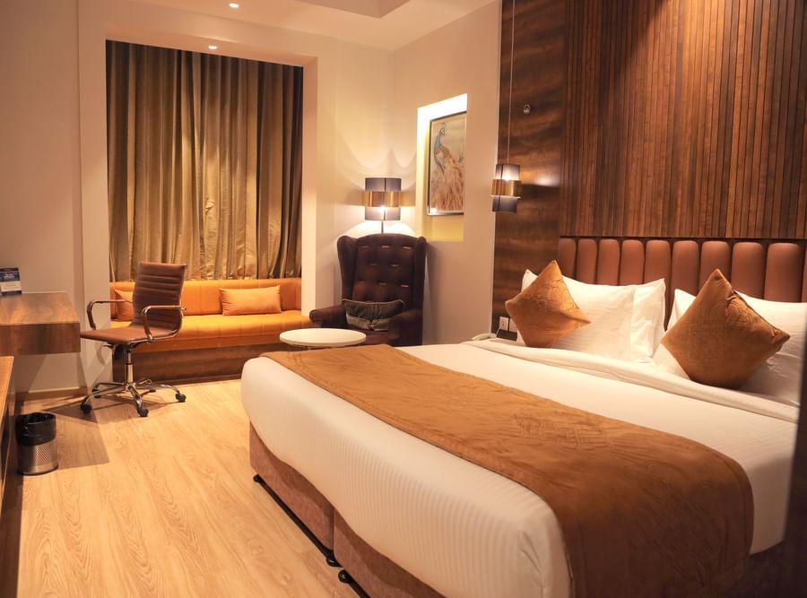 room with a king size bed and wooden flooring at best western vrindavan