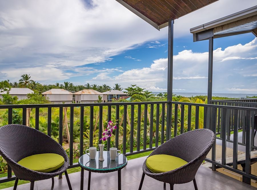 private balcony featuring two chairs along with a coffee table with beautiful views from the balcony