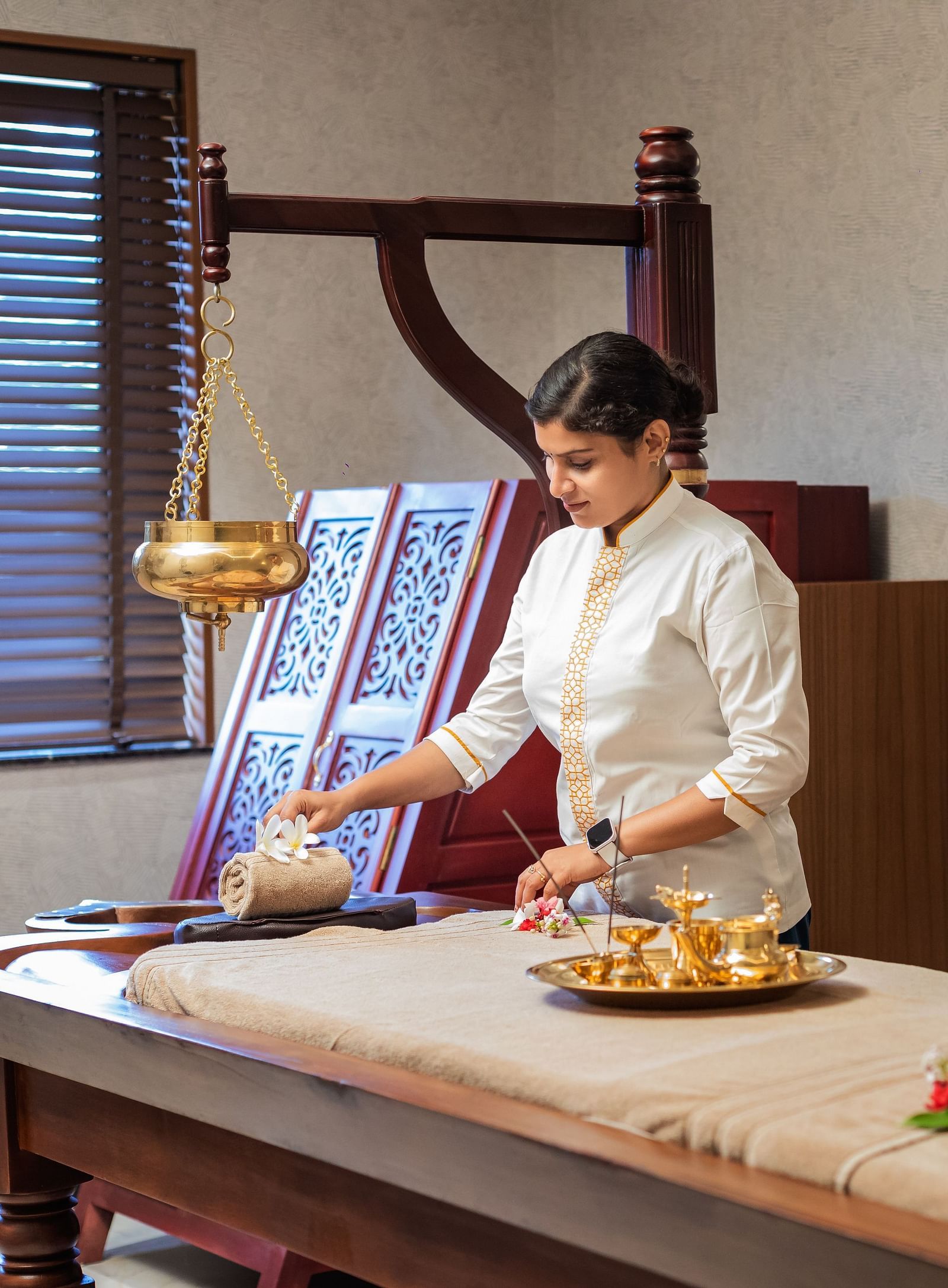 A spa room where a woman can be seen making arrangement for a session - Gamyam Retreat
