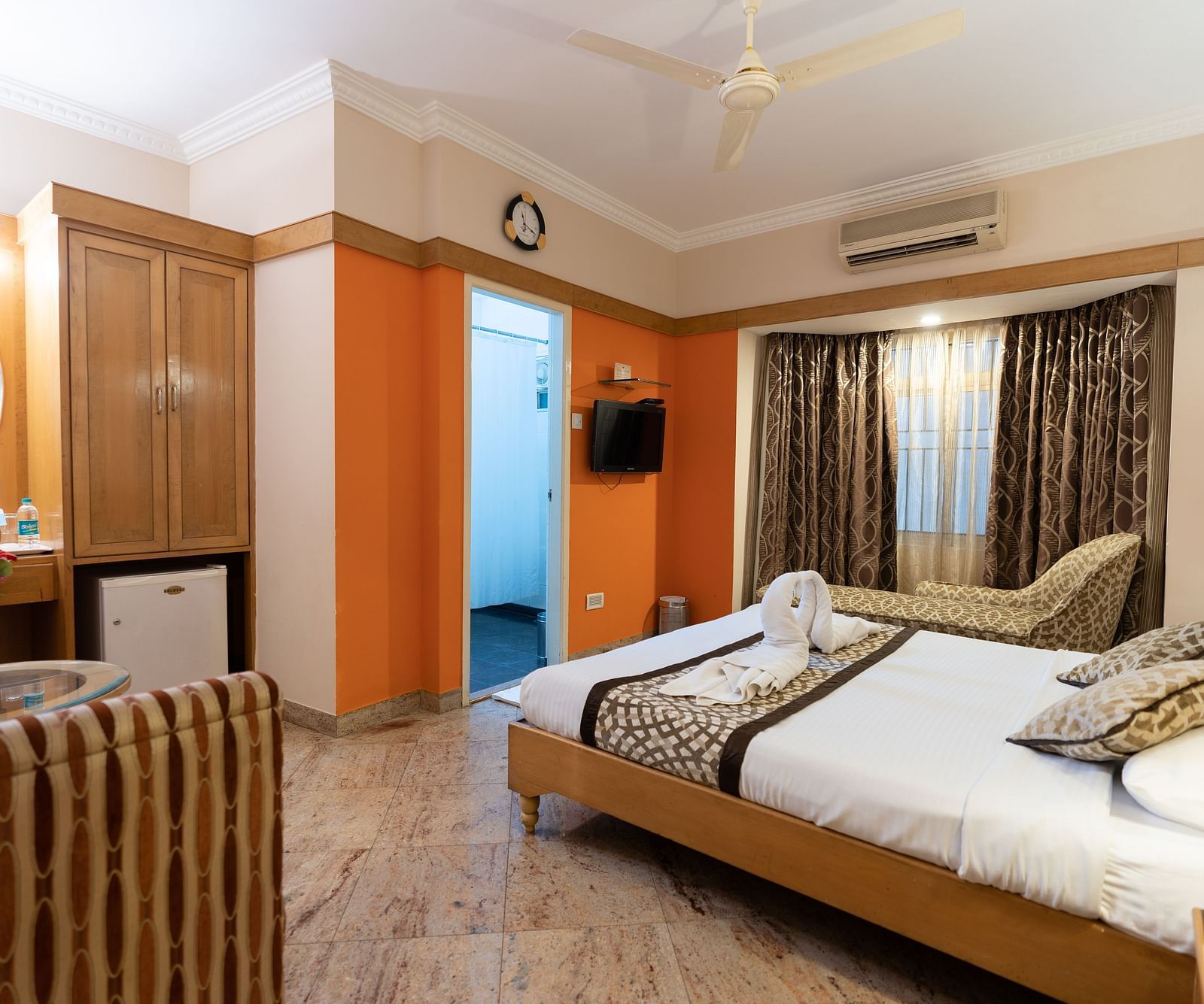 a double with a tv opposite it one of the rooms - Hotel Pai Comforts, JP Nagar