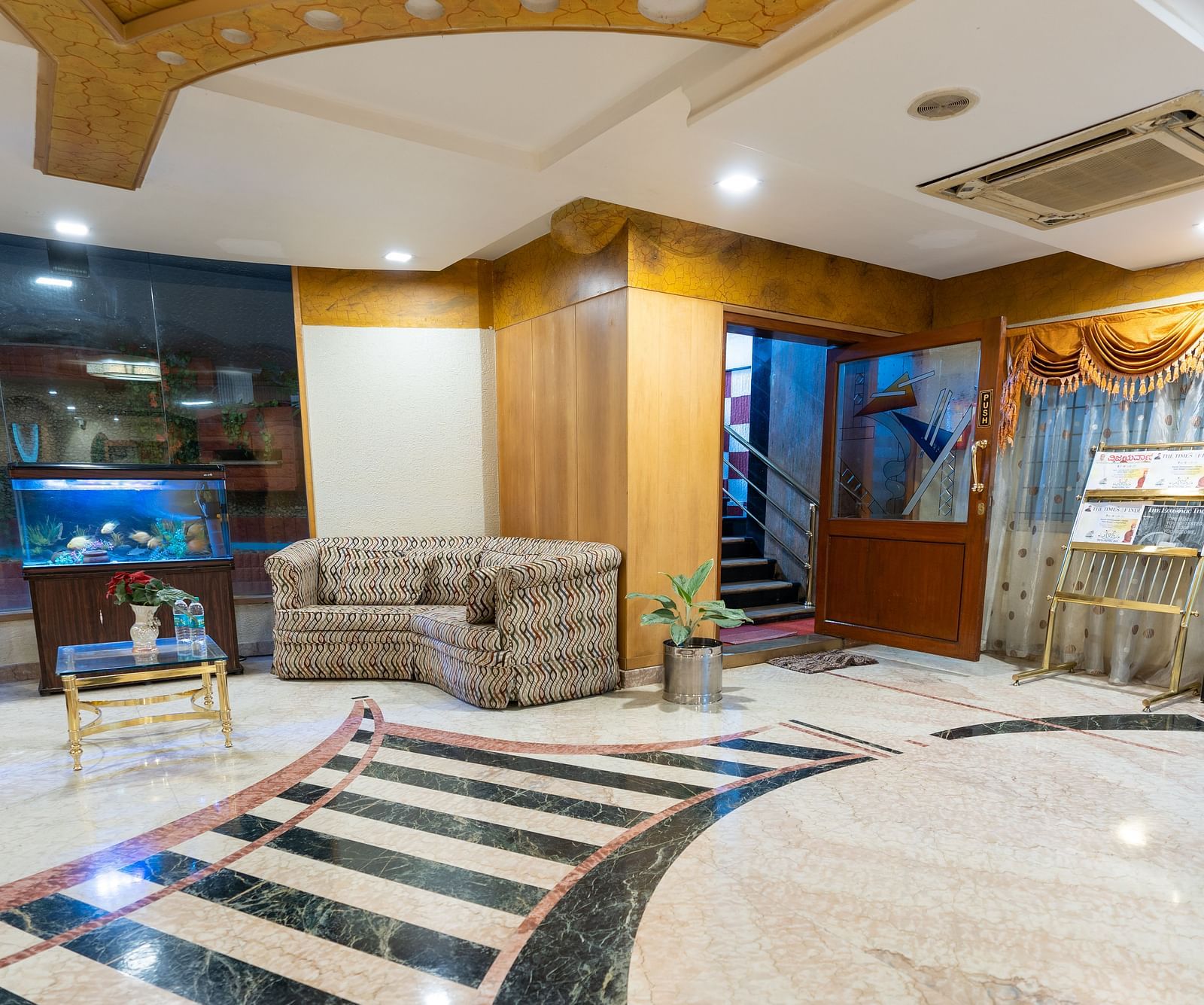 overview of the lobby with seating arrangements inside it - Hotel Pai Comforts, JP Nagar