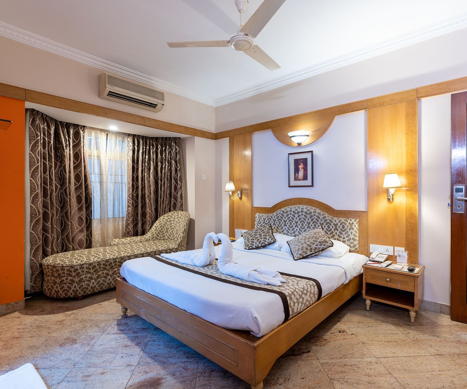 a double bed with a cushioned headboard inside one of the rooms - Hotel Pai Comforts, JP Nagar