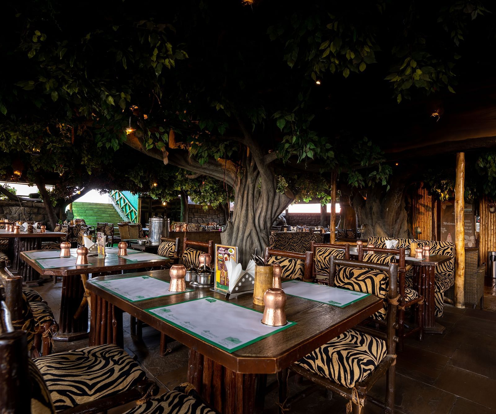 seating arrangements inside one of the restaurants at Hotel Pai Vista, Mysore
