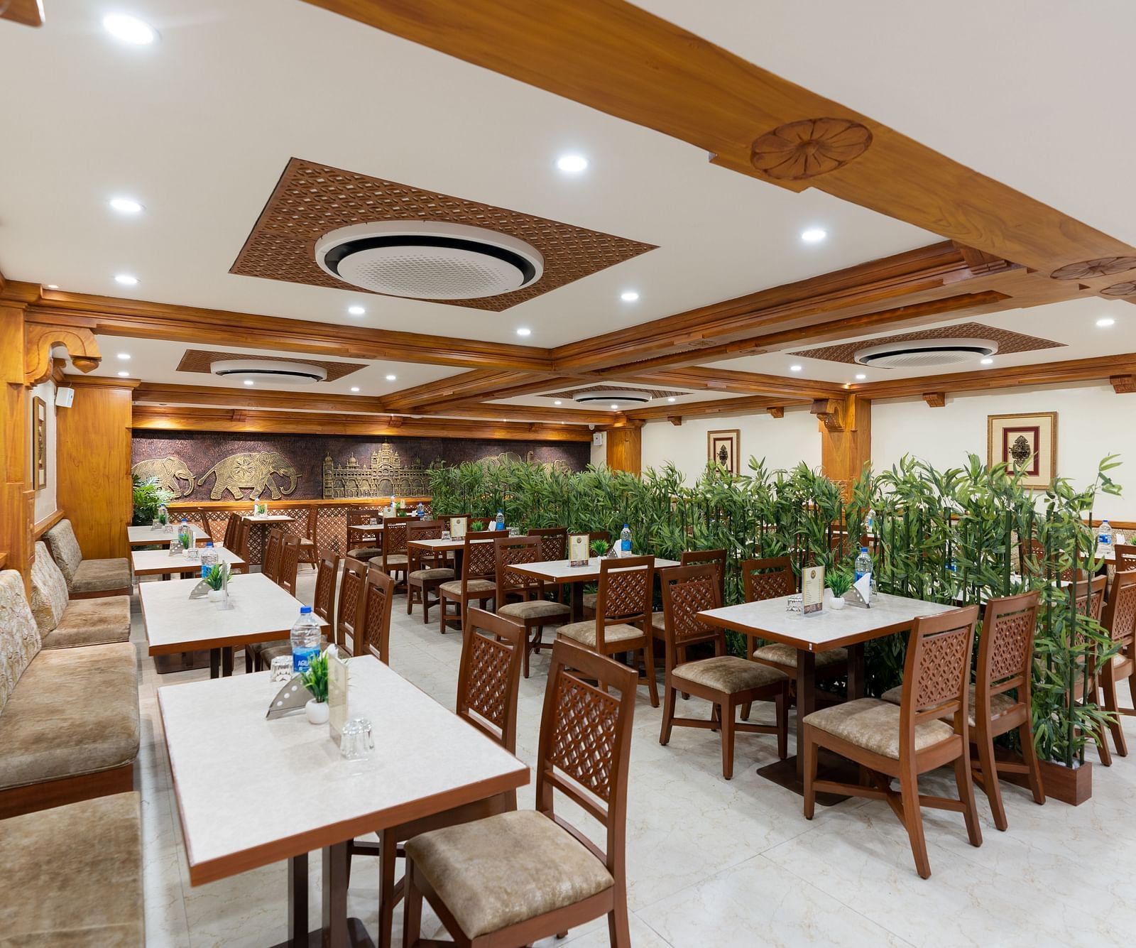 seating arrangements inside the restaurant area - Hotel Pai Vista, Mysore