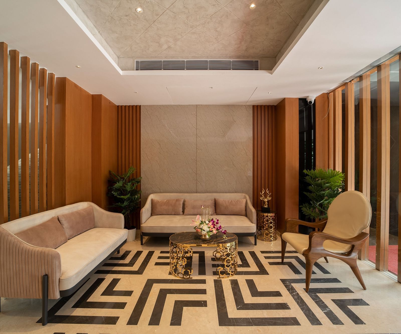 An image of hotel lobby area with geometric patterned flooring and sofas - The President Hotel, Kumara Park, Bangalore