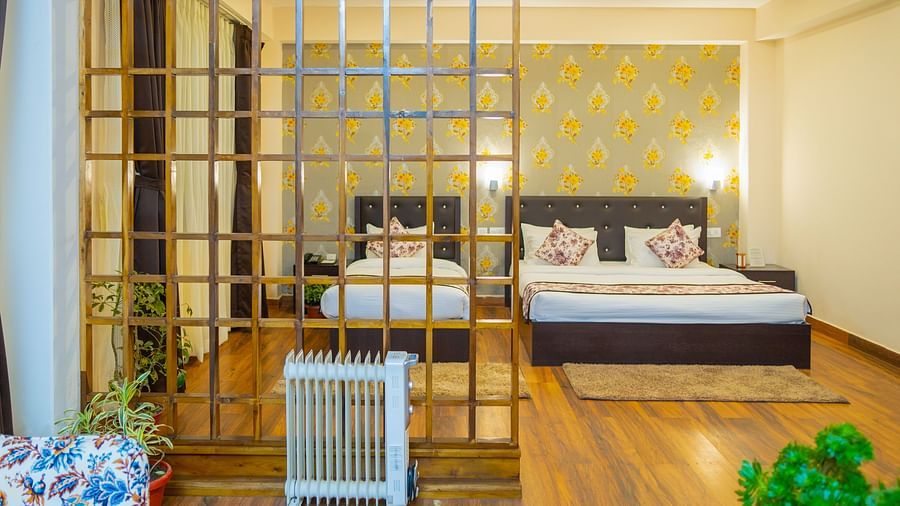 Modern bedroom at Voyage Dream Villa Retreat with decorative grid partition, floral wallpaper, wooden floors, and contemporary furnishings