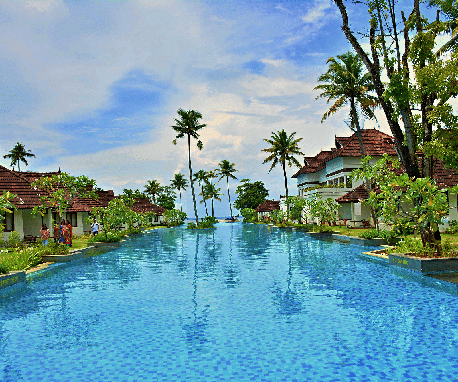 Swimming pool in the centre with resort buildings on the sides - Rhythm Lonavala