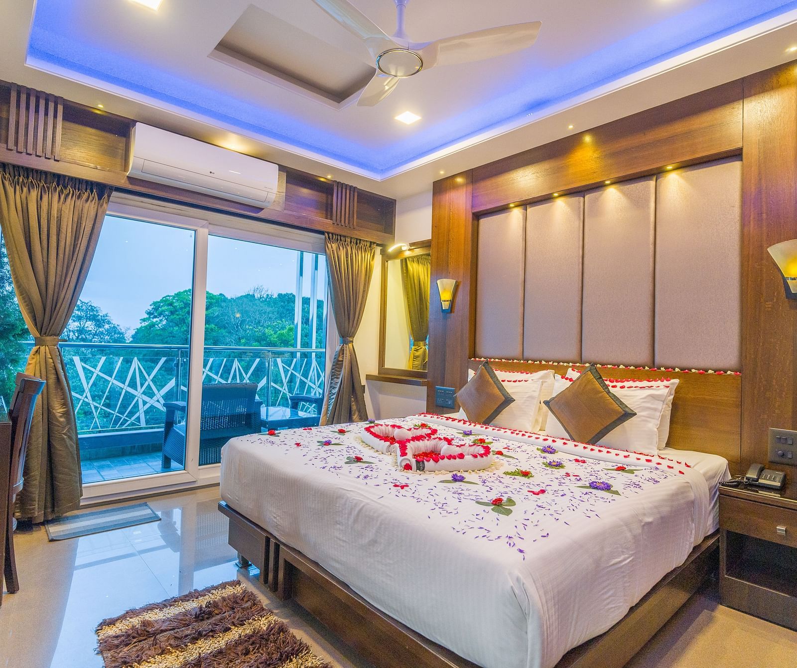 Image of a room with a bed and a sliding door on the left leading to a balcony at Hotel Altitude, Coorg, Madikeri Town.
