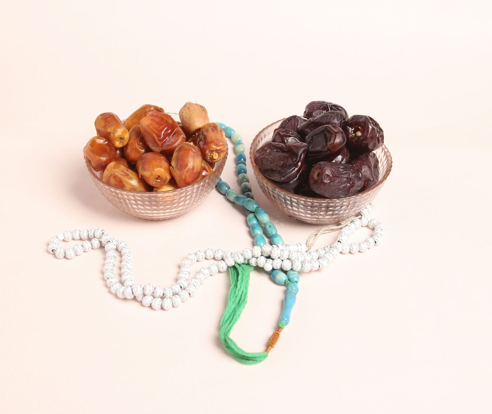 Two bowl with dry fruits two strings attached