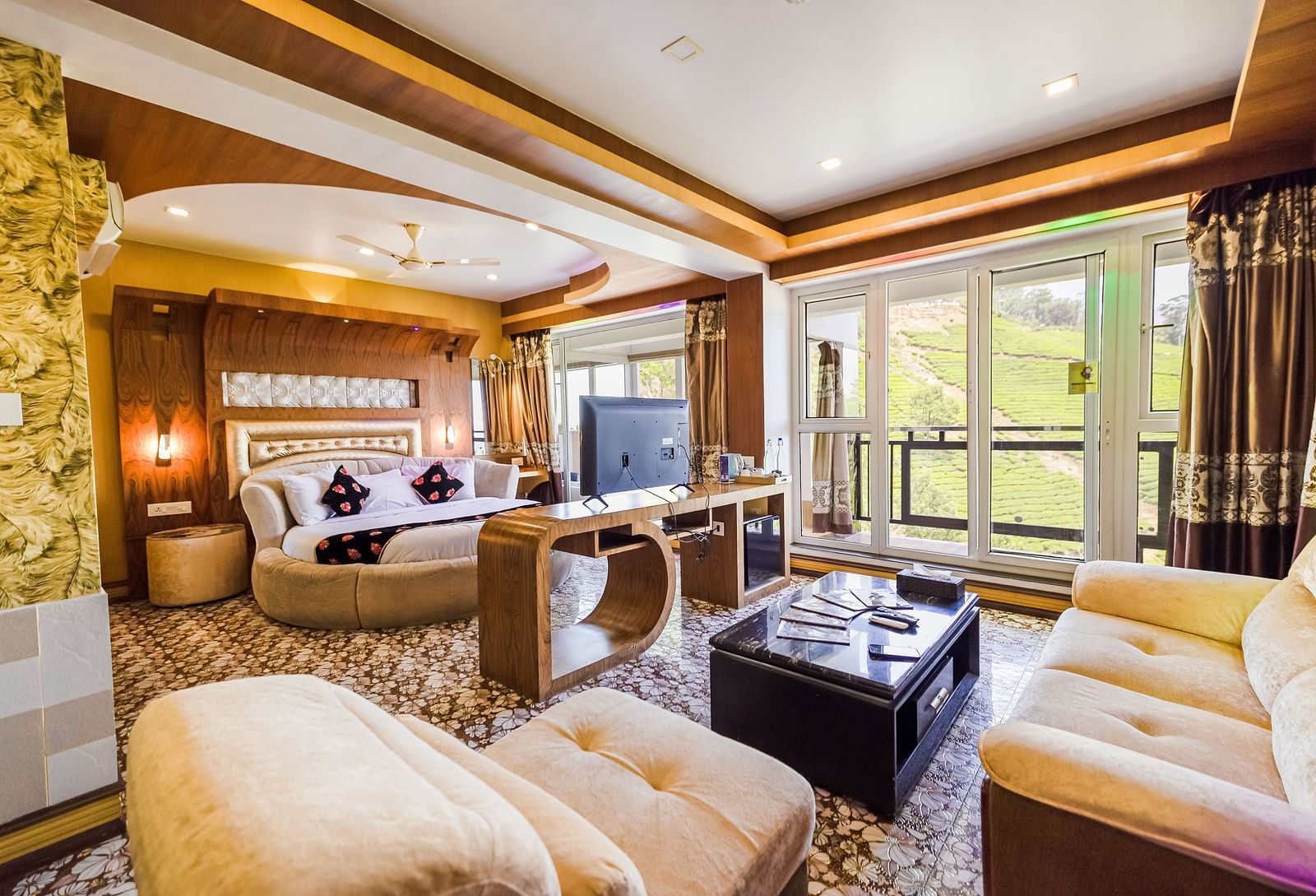 A living area and a round bed in the Honeymoon Suite at Parakkat Nature Hotel and Resorts Munnar 2