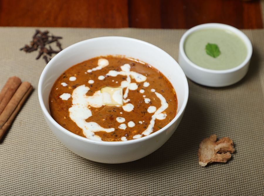 An image dal makhani garnished with cream and there is also a sauce served in bowel beside it at Five Elements Hotel, Jodhpur 