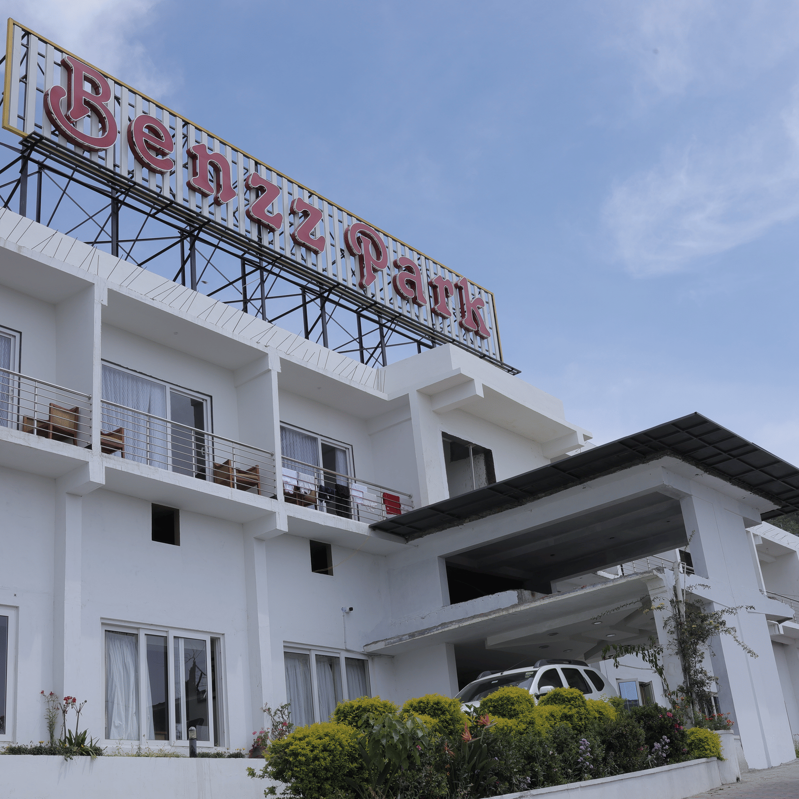 The exterior of Benzz Park, Kodaikanal hotel building under a clear sky.