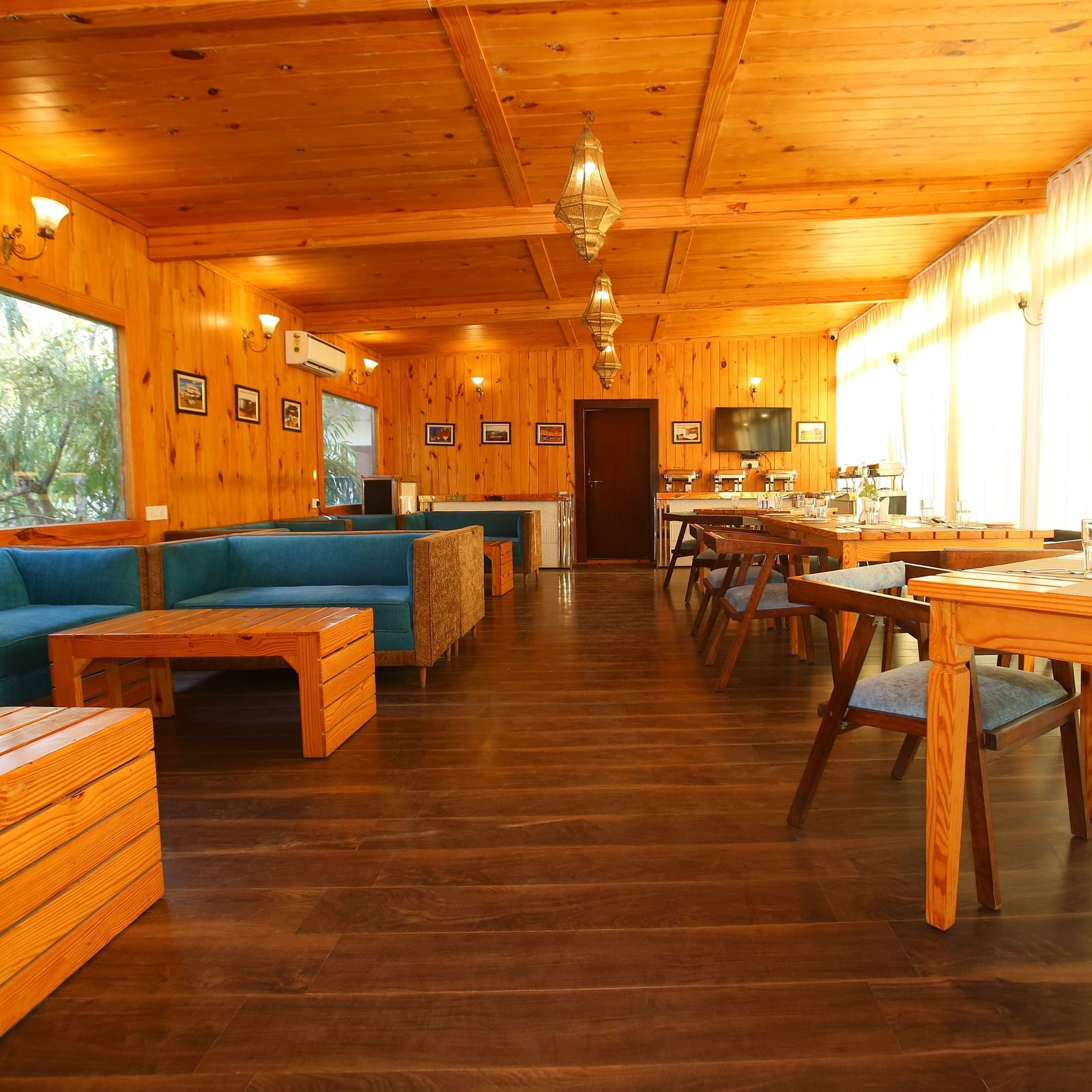 Dining area featuring a large, cozy sofa with a table in front at Aanandam Resort & Spa