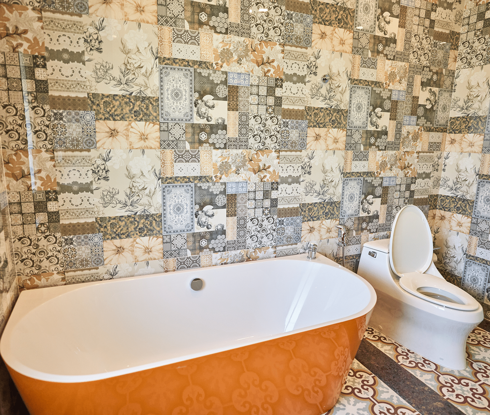 A bathtub with a western toilet to the side at Mayfair Manor, Alibag
