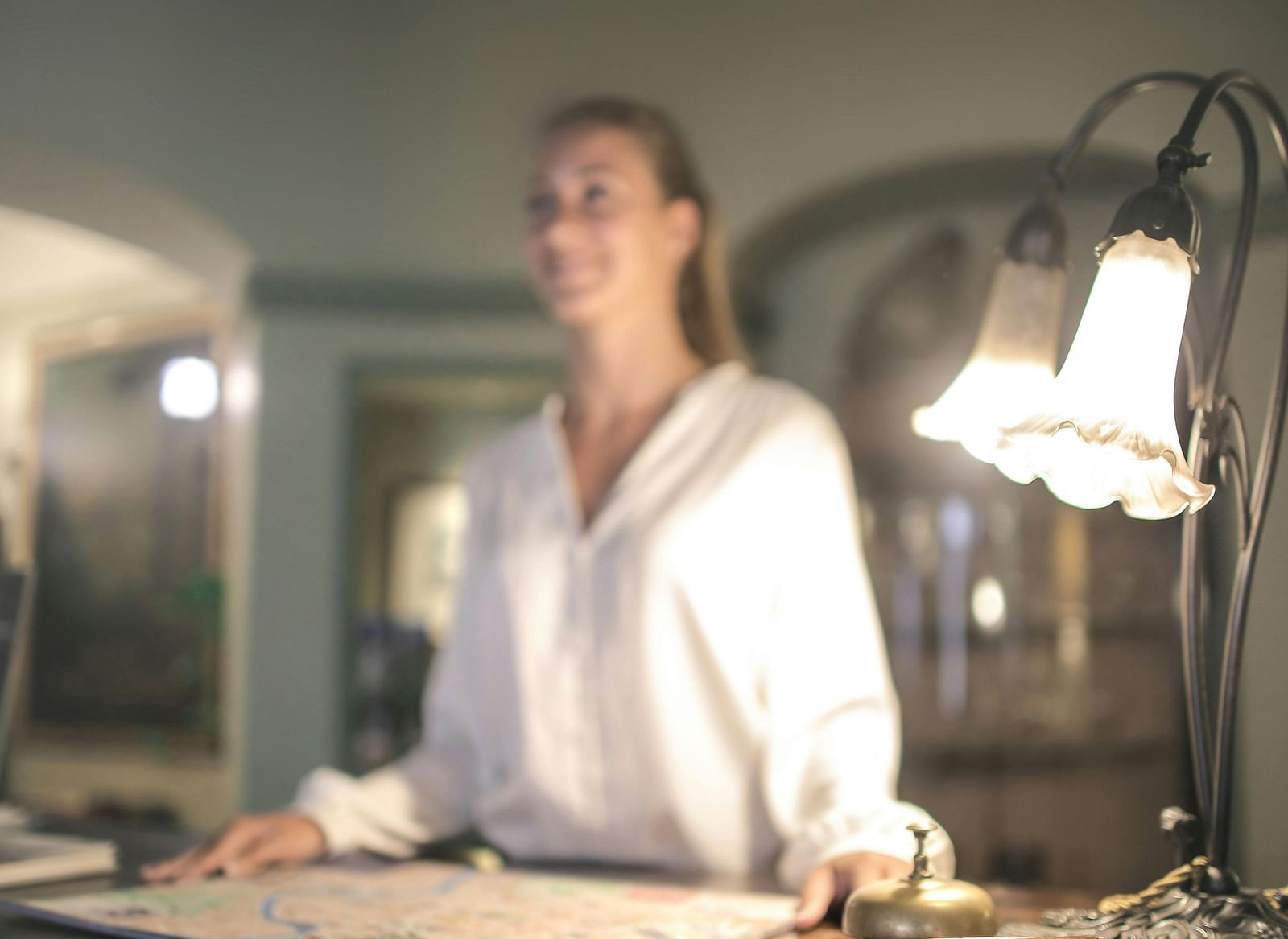 Image of a lady at the reception desk.