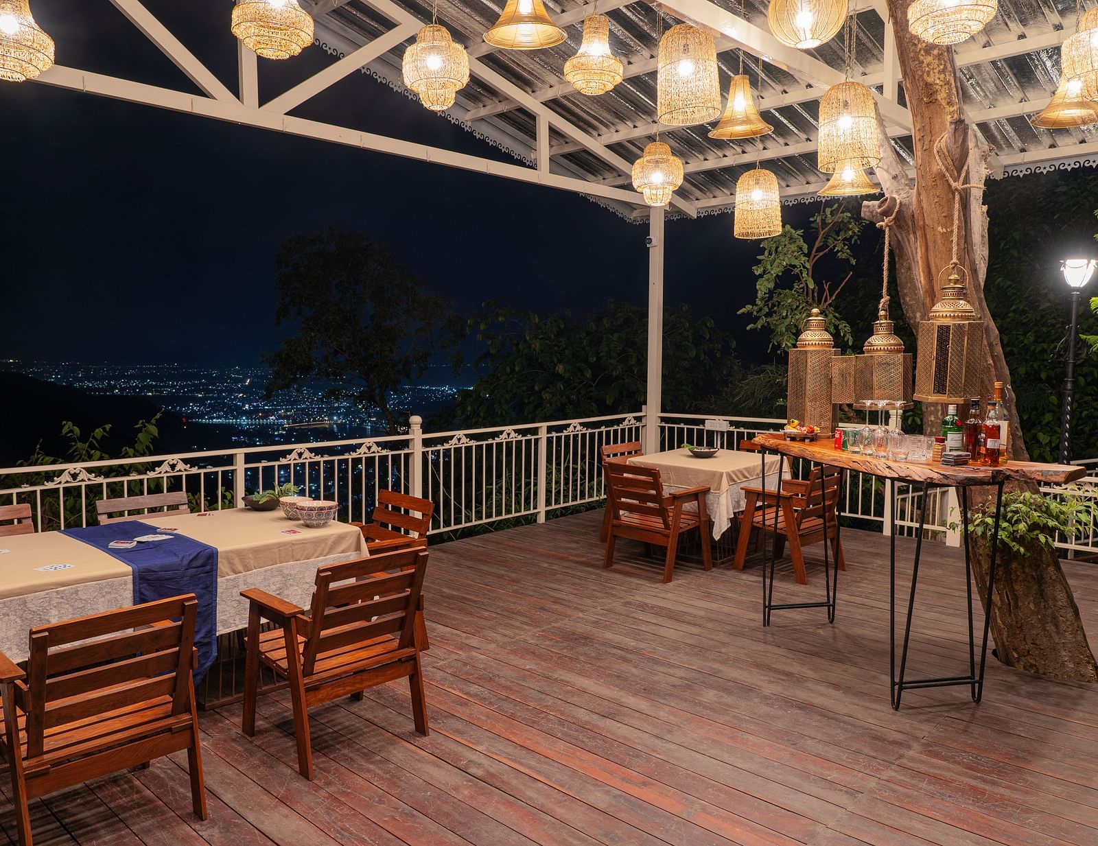 alfresco seating arrangements under a canopy with lights hanging below - neer ganga Resorts