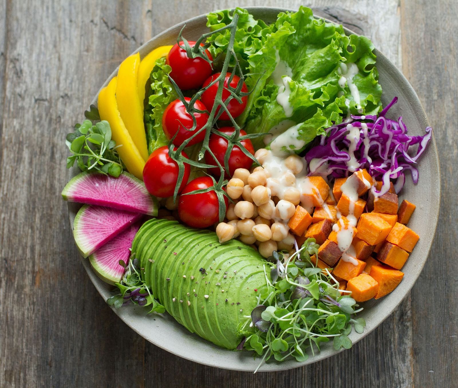 A salad bowl of assorted fresh vegetables.