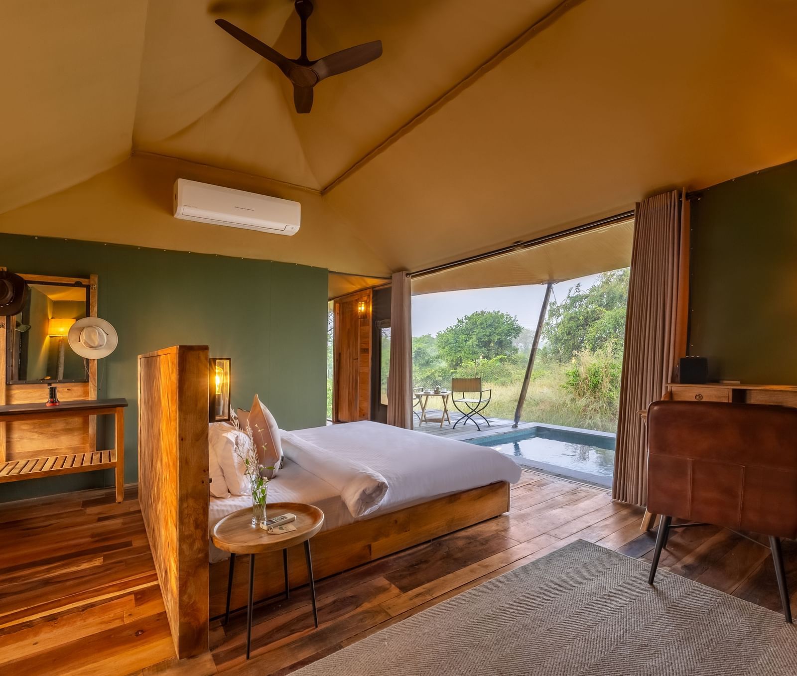An interior of a room with double bed at Trees N Tigers, Tadoba.