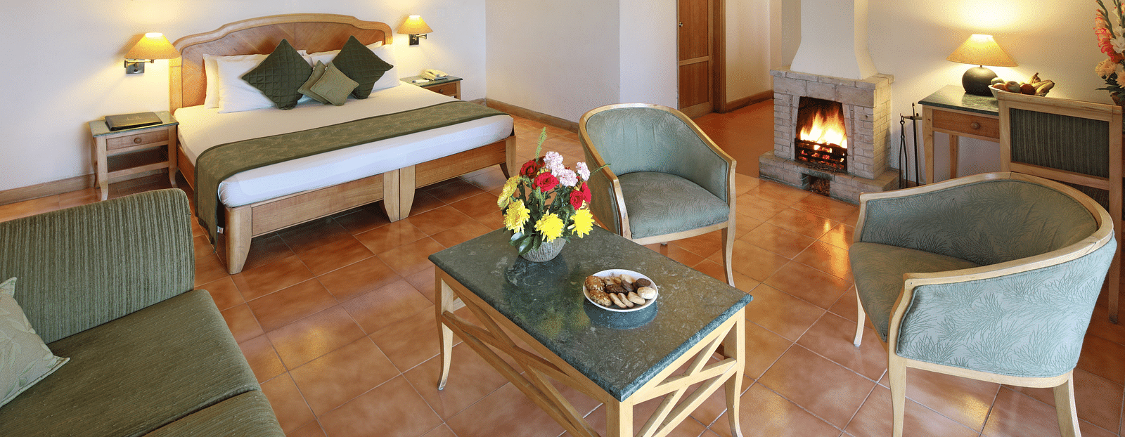 Premium cottage room featuring a cosy bed and a small living area with a sofa and coffee table