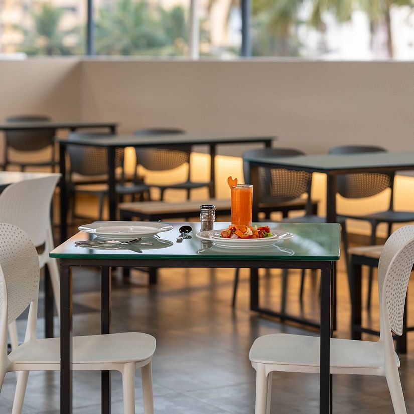 A close up view of our restaurant with comfortable chairs and tables - Court 11, Kochi