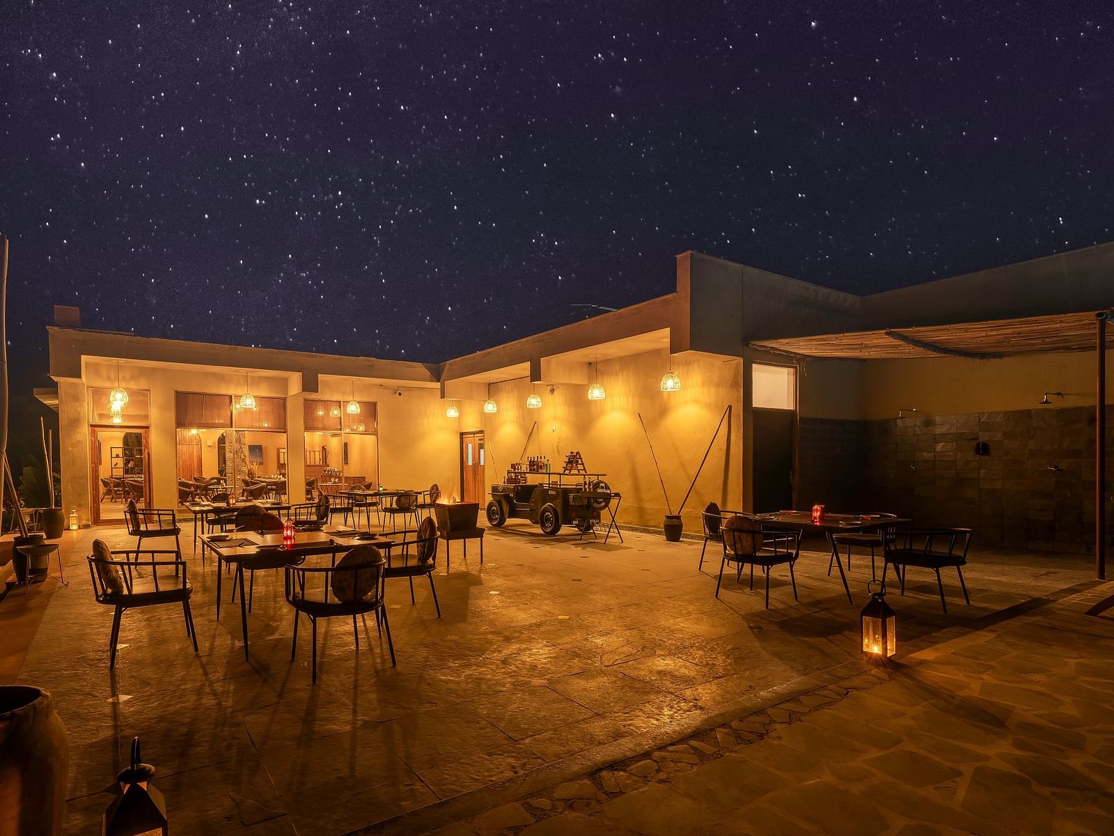 An image of a Rosettes open air restaurant  featuring several sets of tables and chairs and it also has indoor seating spaces - Kurja Jawai