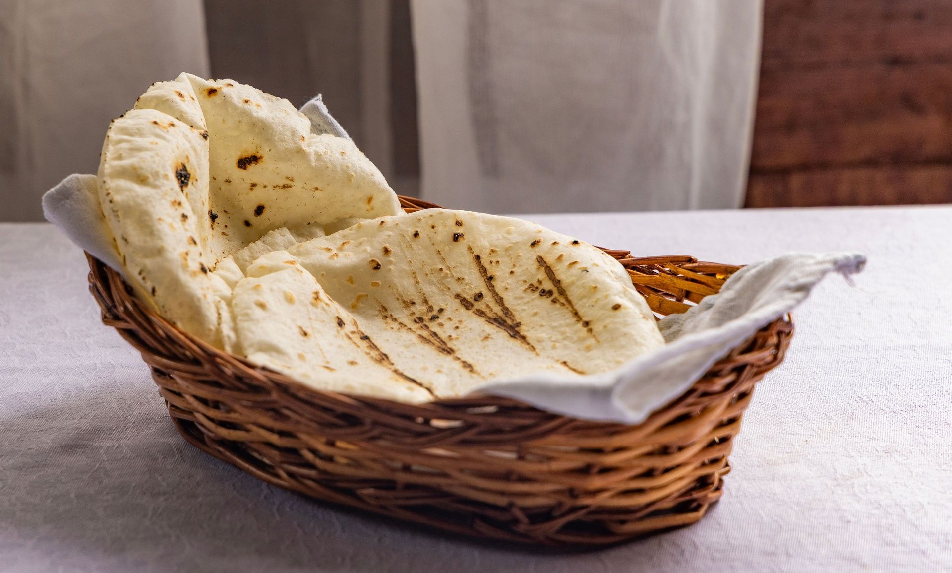 Basket of freshly baked Indian flatbread.