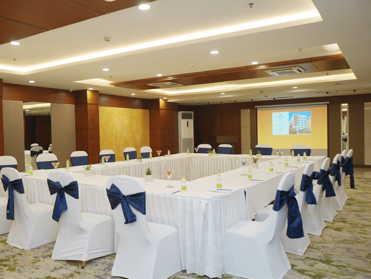 Conference room at Nemesia set up for a meeting with tables arranged in a U-shape.