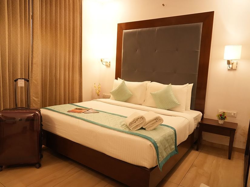 Premium room with a comfortable bed and bedside lights on each side at Clarks Collection, Bhavnagar