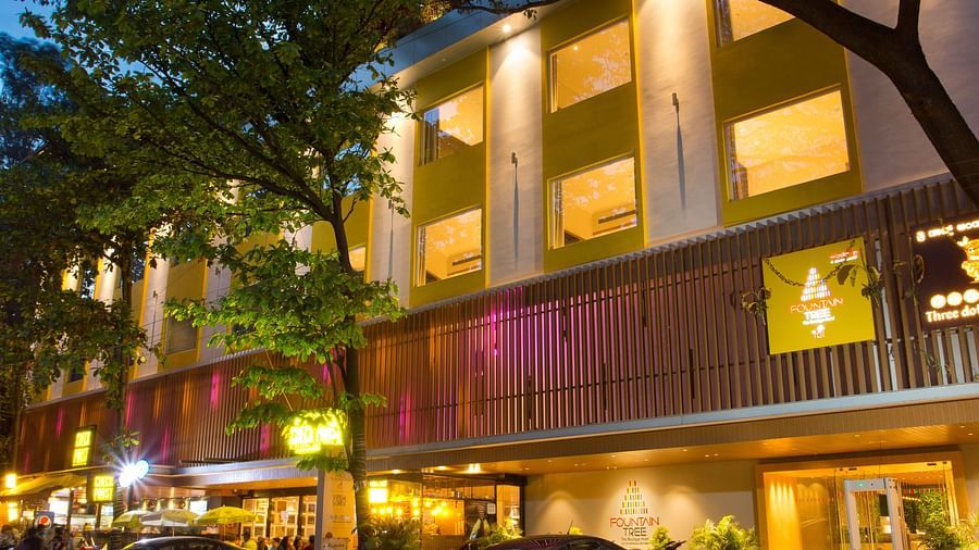 wide view of the facade of the hotel with cars parked outside the front - Hotel Fountain Tree By TGI - JP Nagar, Bangalore