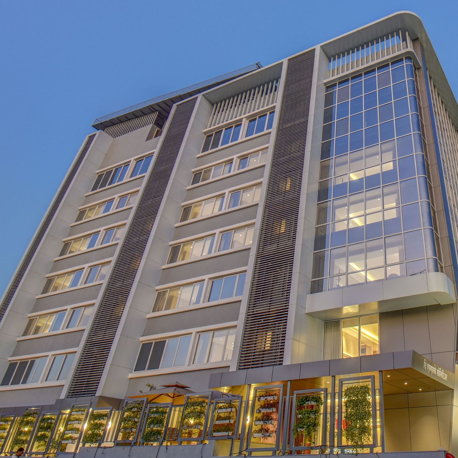 Low angle shot of Facade of  The SSK Solitaire Boutique Hotel & Spa, Gangapur Road - Nashik with backdrop of blue sky