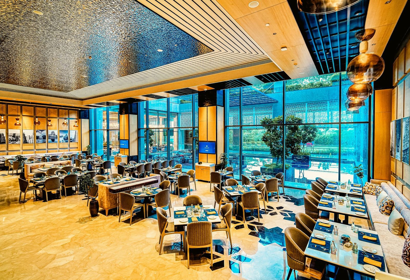 A bright and modern dining area with floor-to-ceiling windows, offering a relaxed and open atmosphere