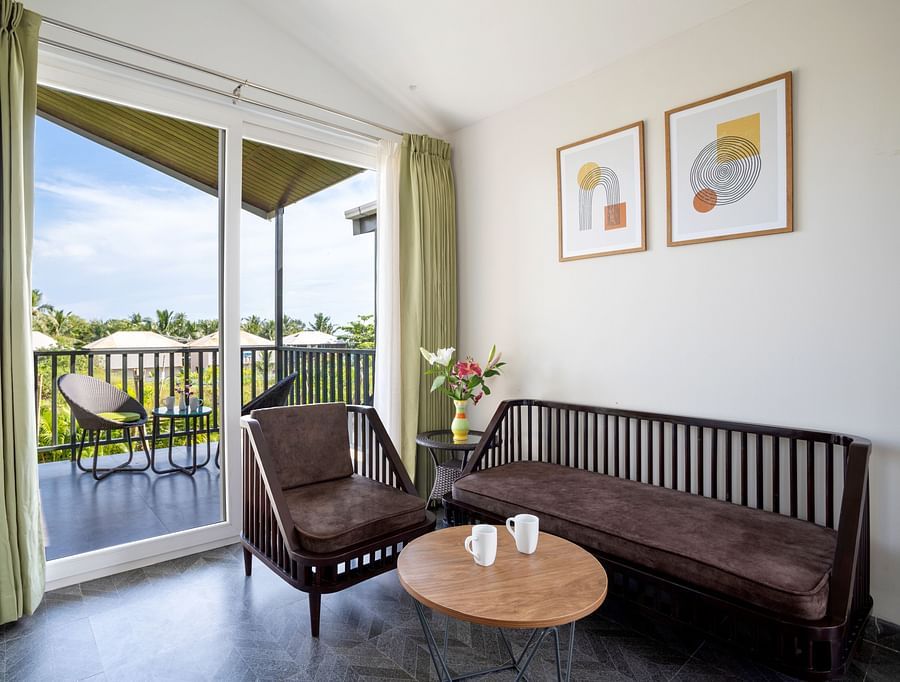 image of the living area with huge french windows that open to the outdoor sit out area at the Premium Suite