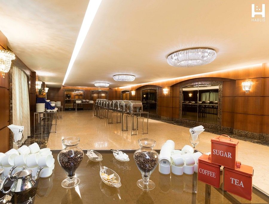 glasses and plates arranged in a banquet hall