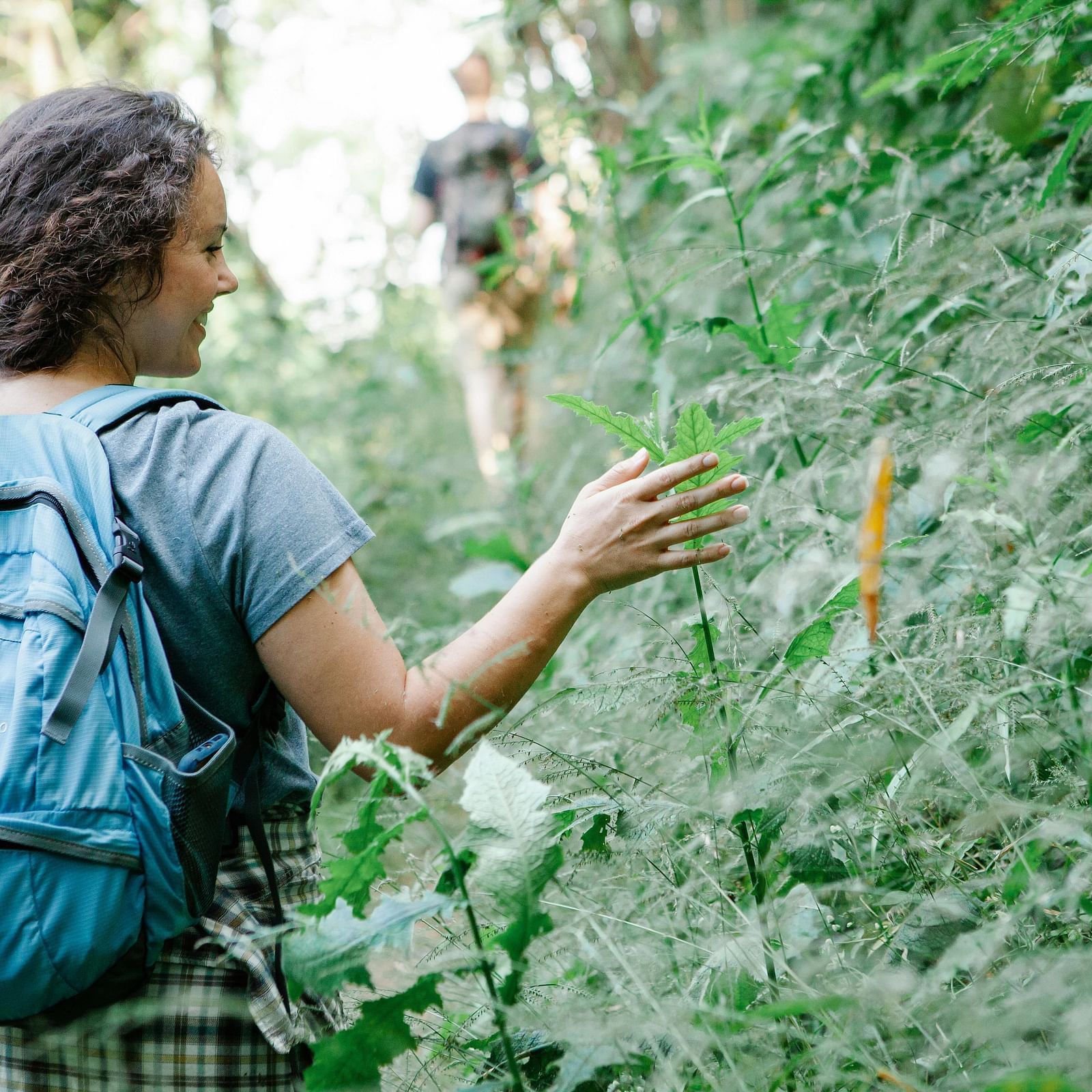 a woman embracing the bushes at a walking safari