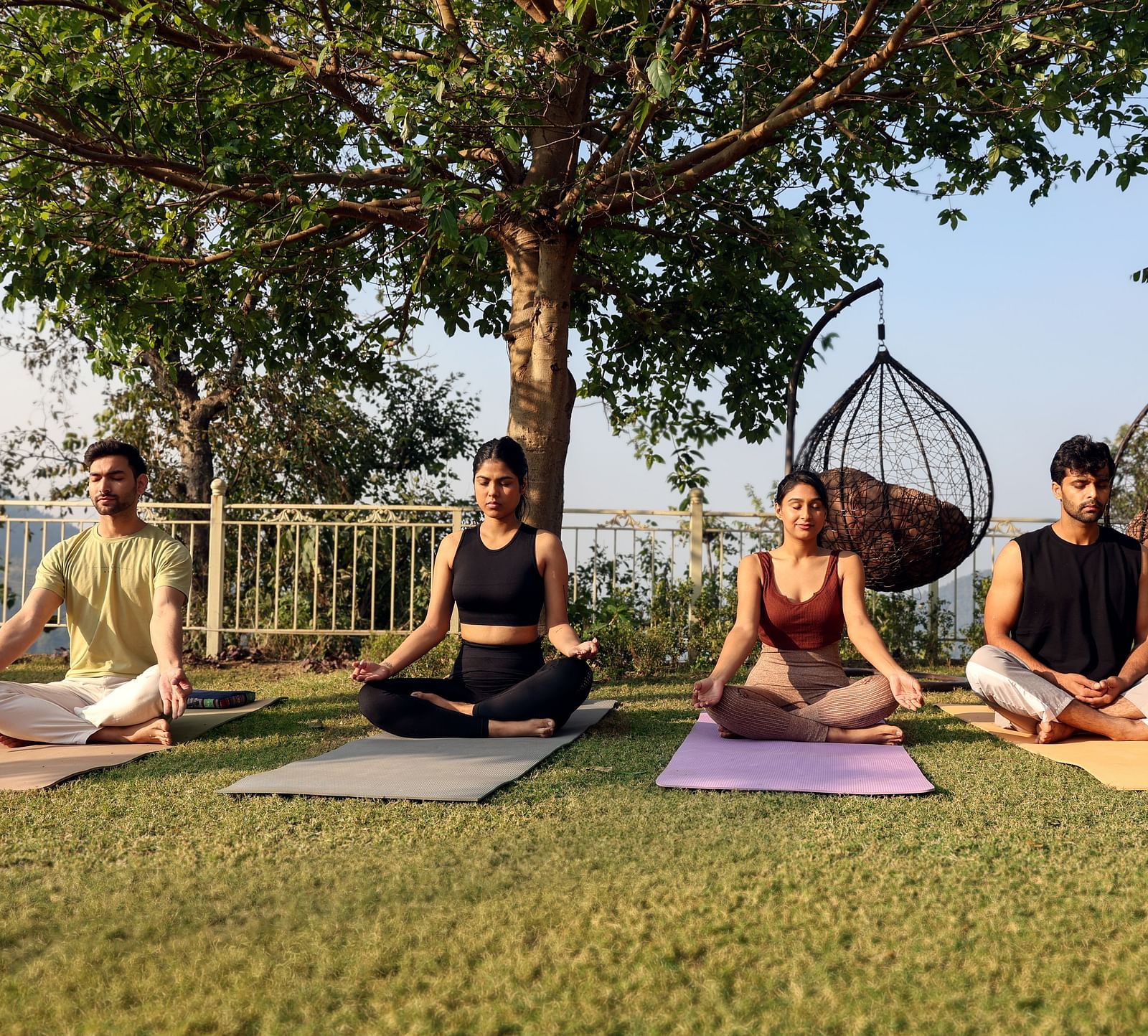people sitting on yoga mat and meditating