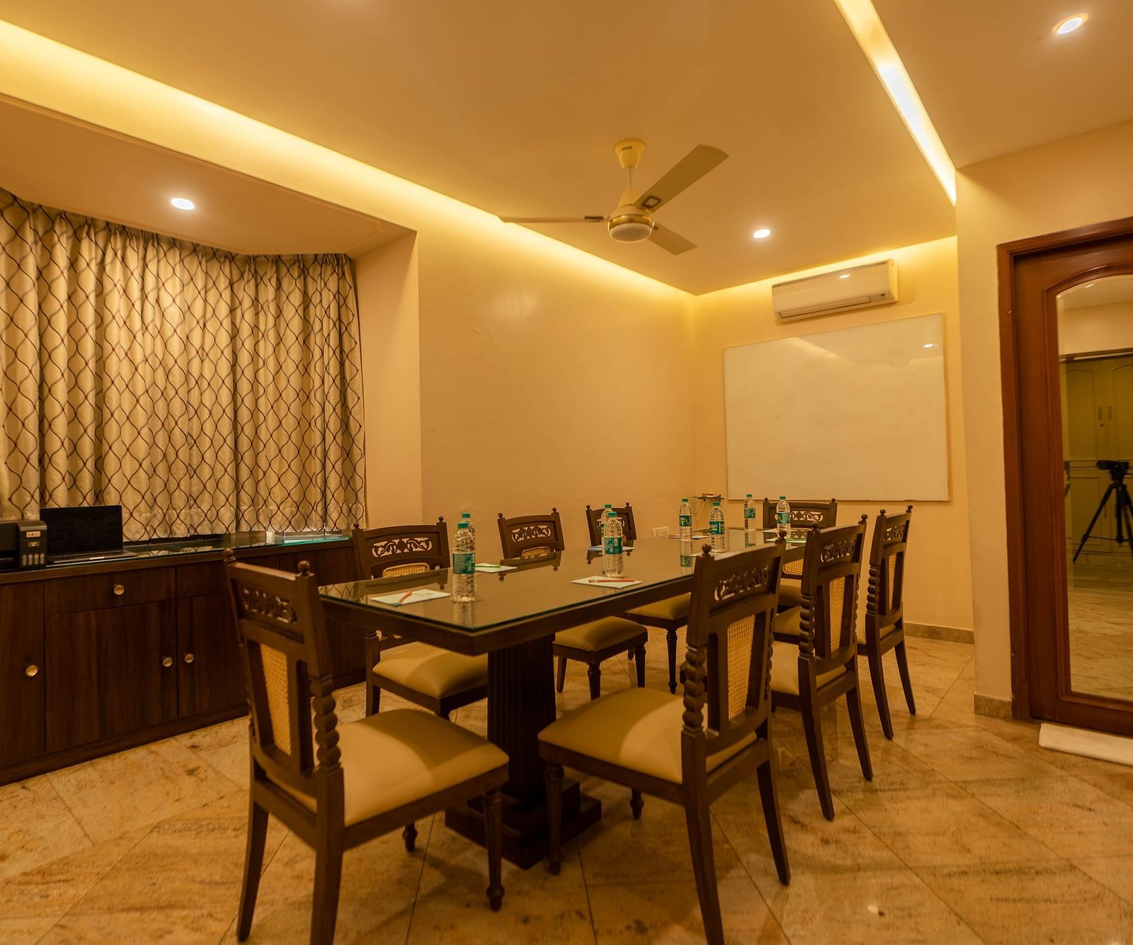 A meeting room at Hotel Pai Viceroy Jayanagar featuring seating for 8 persons, a white board and air-conditioning