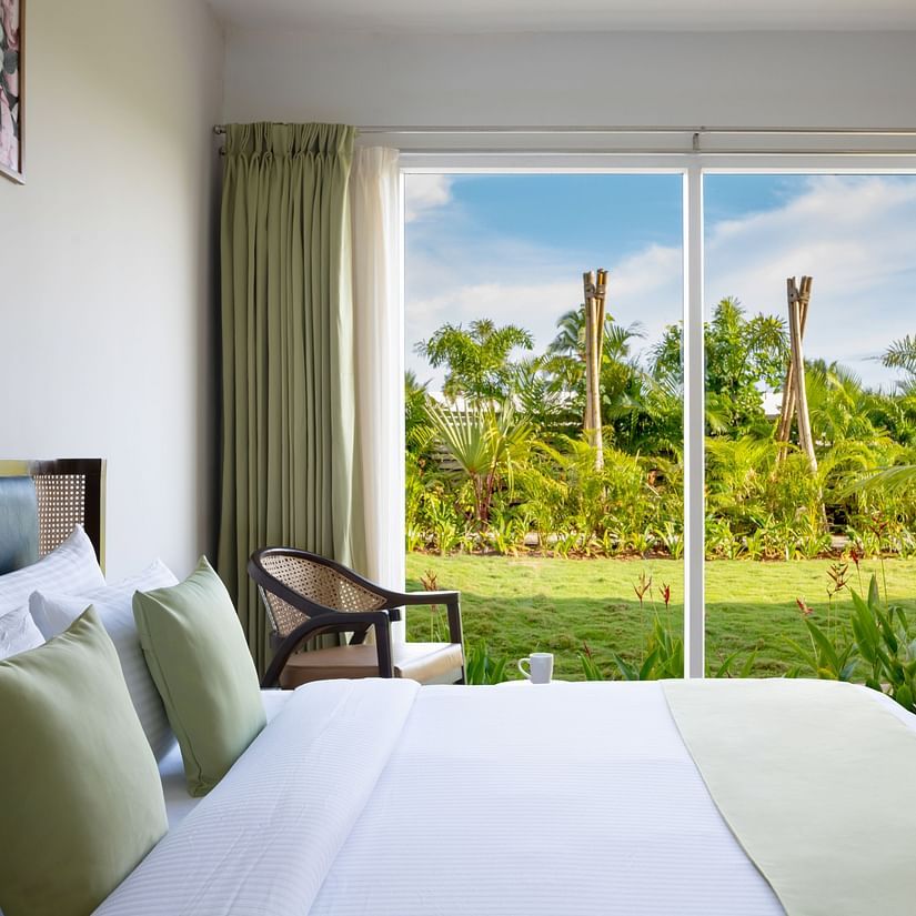 image of the bedroom of garden suite featuring the huge french windows with amazing views outside with ample natural light in the room