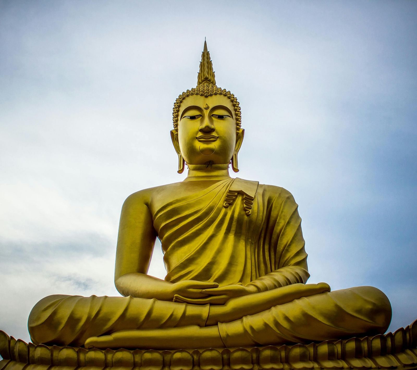 A towering Buddha statue set against the open sky